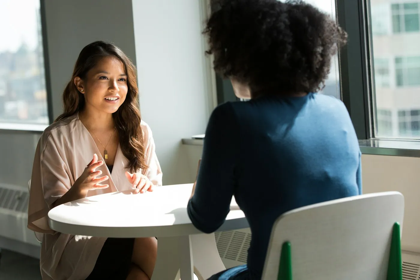 Candidate answering questions across the table in a job interview