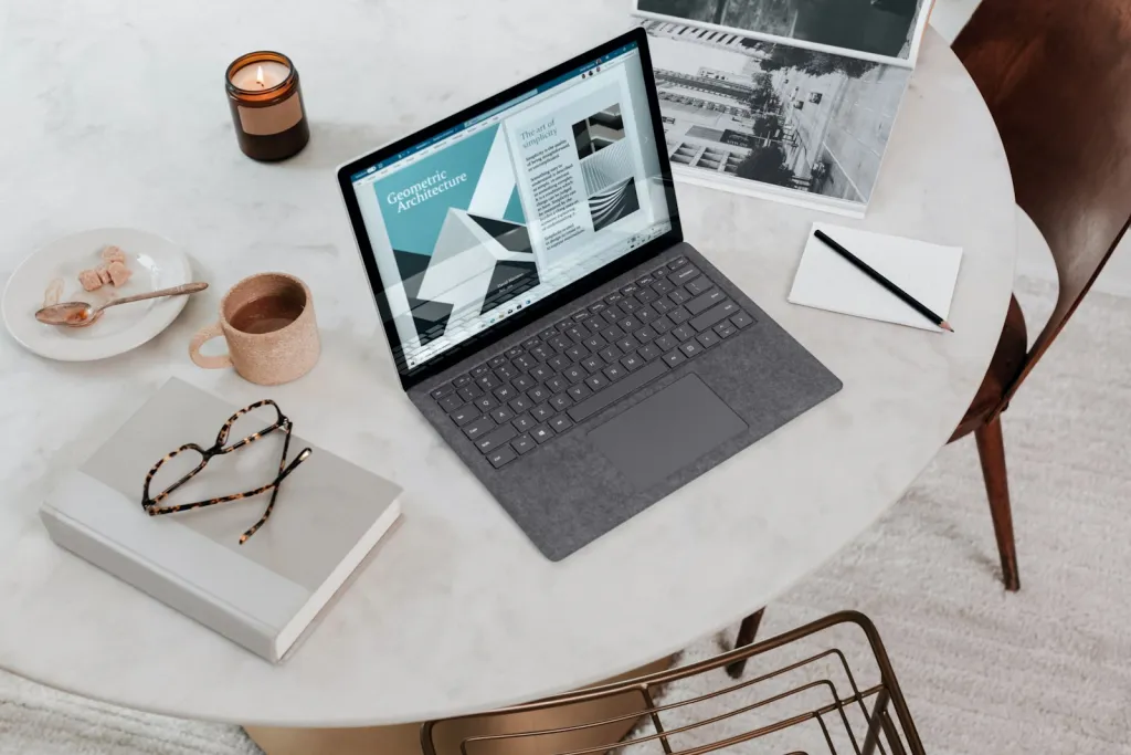 Laptop, notebook and coffee on a marble desk