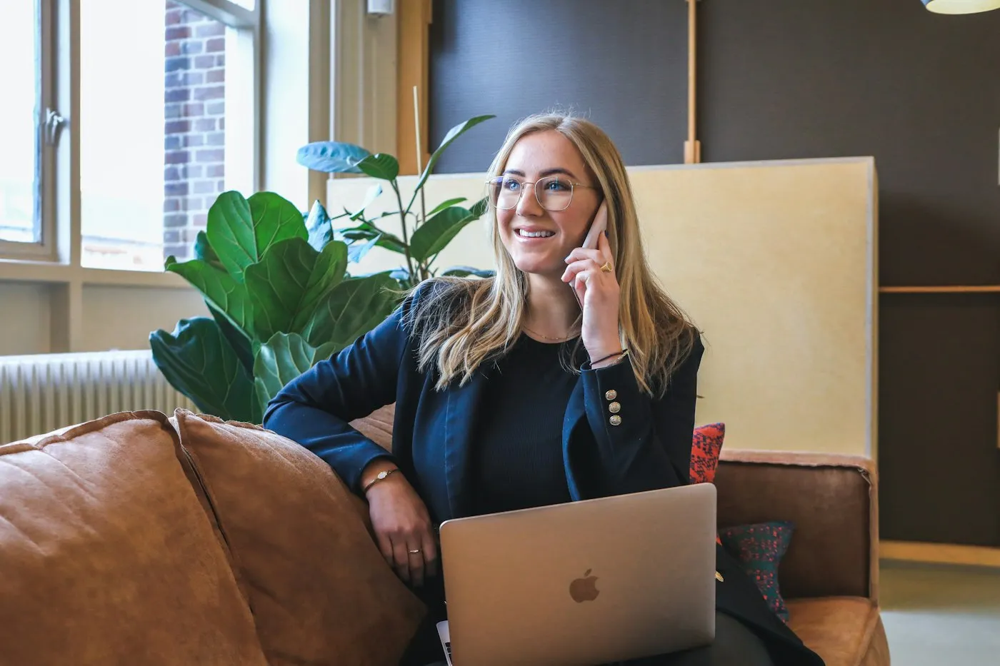 Sales professional on a phone call with her laptop open